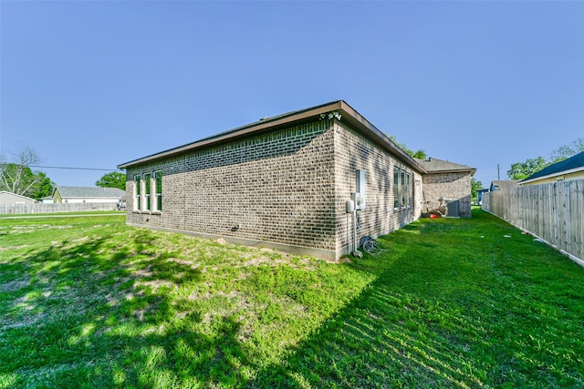 view of property exterior featuring a lawn and central AC unit