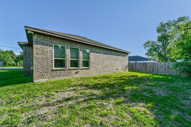 view of property exterior featuring a lawn