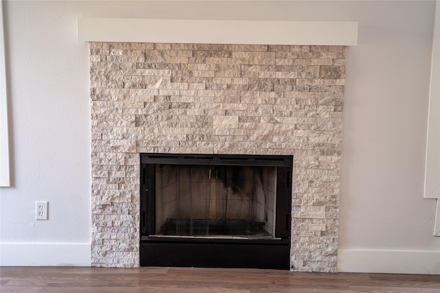 details with a fireplace and wood-type flooring