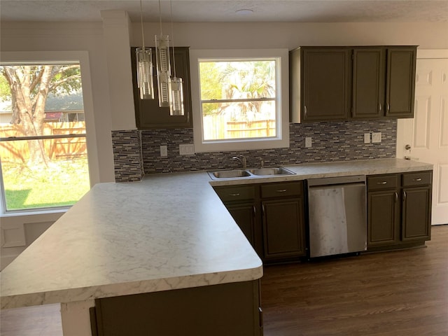 kitchen featuring a wealth of natural light, tasteful backsplash, sink, stainless steel dishwasher, and dark brown cabinets