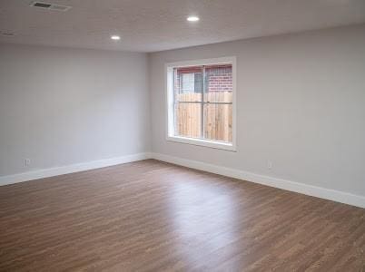 empty room featuring dark hardwood / wood-style flooring