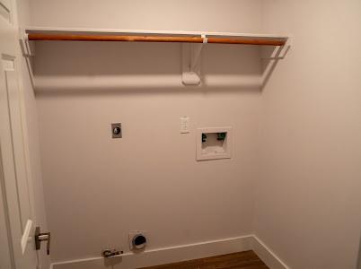 clothes washing area featuring hookup for a washing machine, wood-type flooring, hookup for an electric dryer, and hookup for a gas dryer