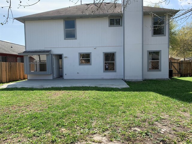 rear view of property featuring a yard and a patio