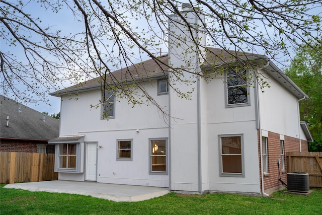 back of house with a patio, a lawn, and central air condition unit