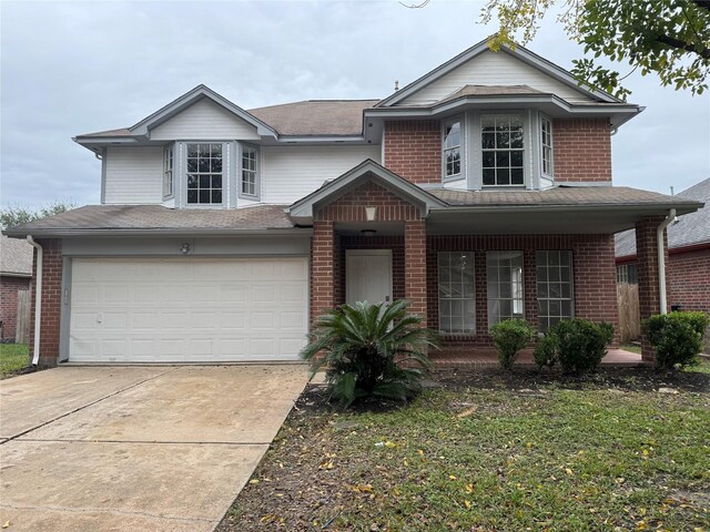 front of property featuring a porch and a garage