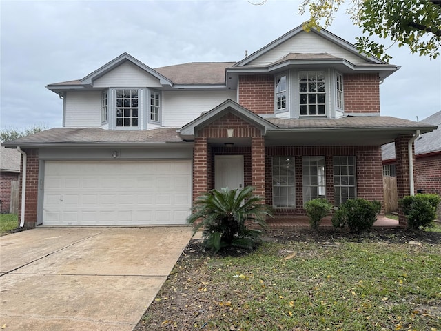 front of property featuring a garage and covered porch