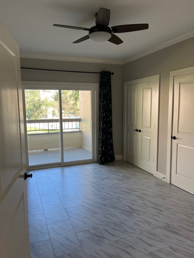 unfurnished room featuring ceiling fan and ornamental molding