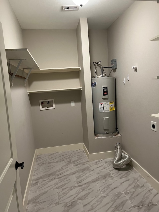 clothes washing area with electric water heater, washer hookup, and hookup for an electric dryer