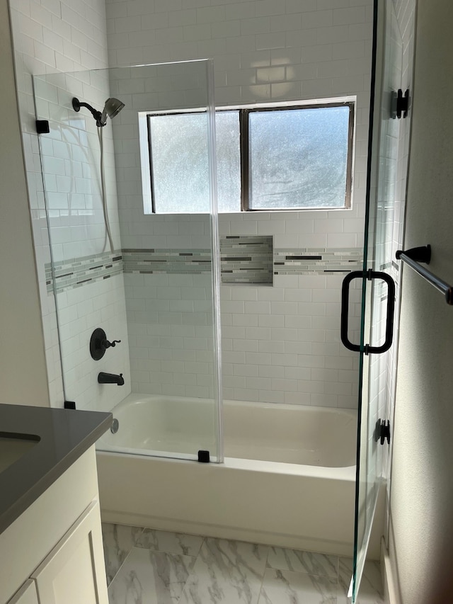 bathroom featuring tiled shower / bath, vanity, and plenty of natural light