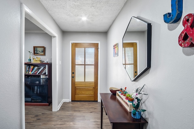 4515 Ponca St, Pasadena, TX 77504 - foyer with wood finished floors, a textured ceiling, and baseboards