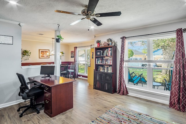 office area featuring crown molding, ceiling fan, light hardwood / wood-style floors, and a textured ceiling