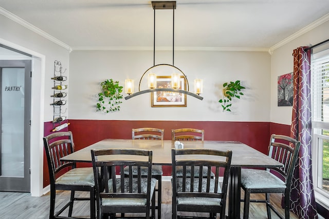 dining area featuring hardwood / wood-style flooring, a notable chandelier, and ornamental molding