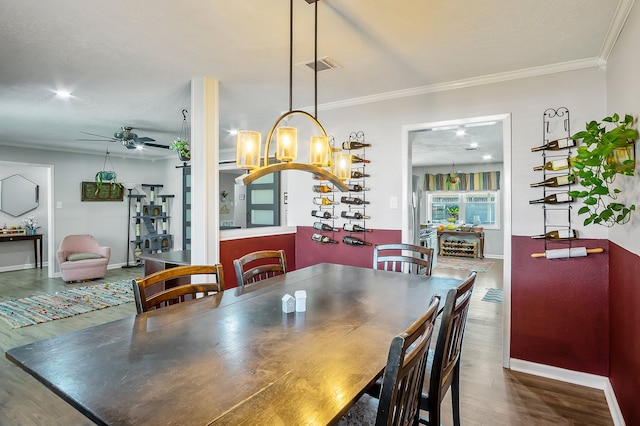 4515 Ponca St, Pasadena, TX 77504 - dining space with wood finished floors, ceiling fan, crown molding, baseboards, and a chandelier