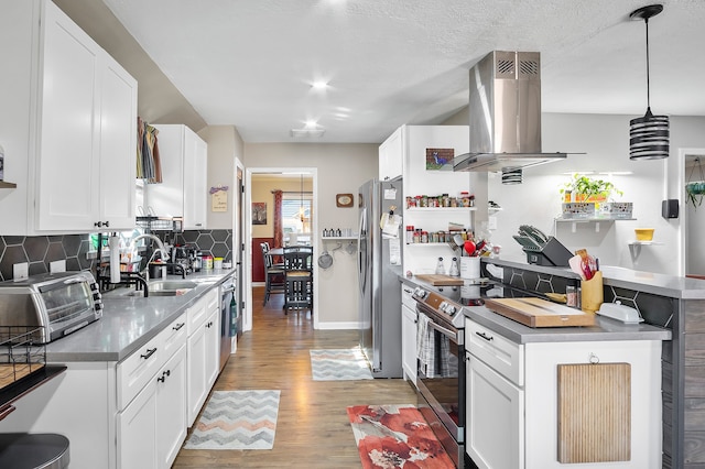 4515 Ponca St, Pasadena, TX 77504 - kitchen with appliances with stainless steel finishes, island exhaust hood, a sink, light wood-type flooring, and decorative backsplash