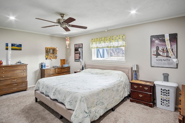 bedroom with ceiling fan, ornamental molding, and light carpet