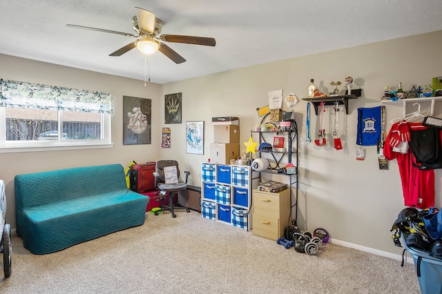 living area with carpet flooring, ceiling fan, and a textured ceiling