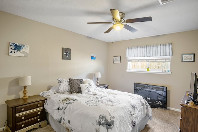 bedroom with ceiling fan and light carpet