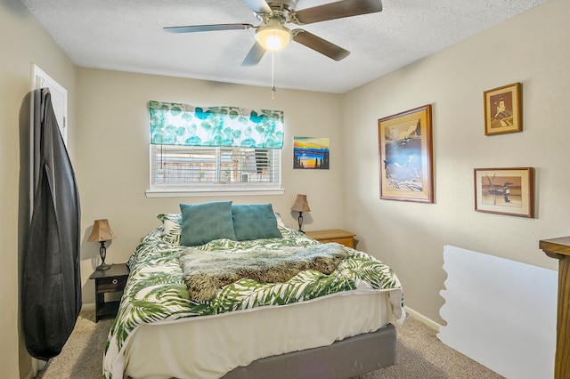 carpeted bedroom featuring a textured ceiling and ceiling fan