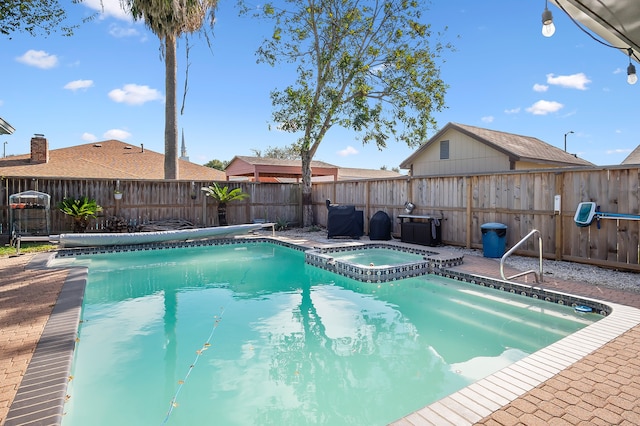 view of pool with an in ground hot tub