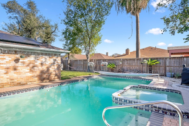 view of swimming pool featuring an in ground hot tub