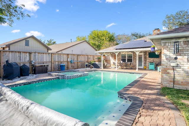 view of pool featuring an in ground hot tub and a patio