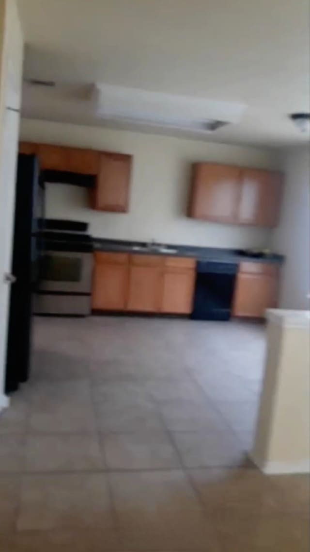 kitchen with white stove and exhaust hood