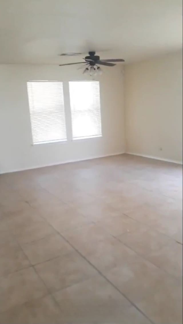 spare room with plenty of natural light and ceiling fan