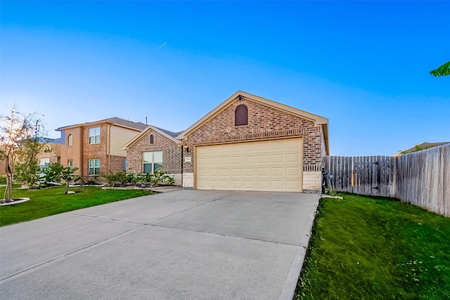 view of front of home featuring a garage and a front yard