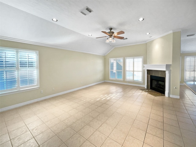 unfurnished living room featuring light tile patterned floors, vaulted ceiling, ceiling fan, and a healthy amount of sunlight