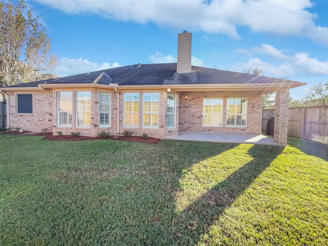 back of house featuring a patio area and a yard