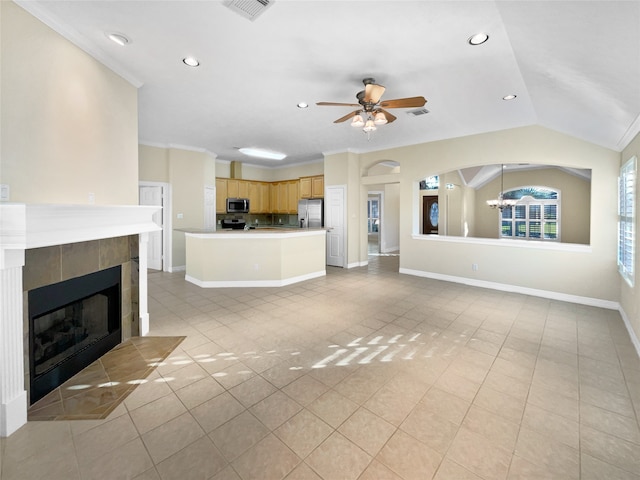 unfurnished living room featuring crown molding, lofted ceiling, a fireplace, light tile patterned floors, and ceiling fan with notable chandelier