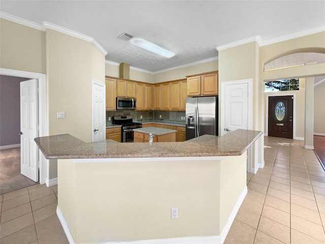 kitchen with decorative backsplash, appliances with stainless steel finishes, ornamental molding, light tile patterned floors, and a large island