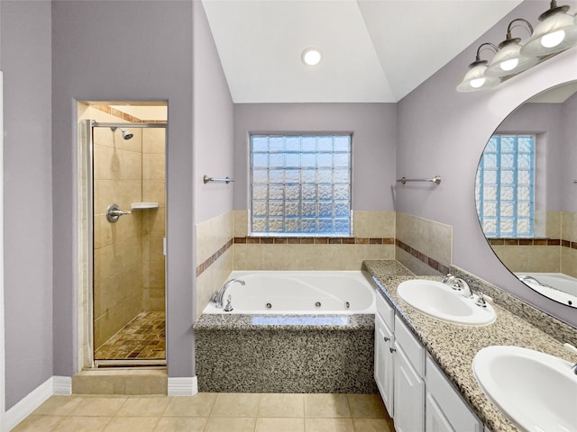 bathroom featuring tile patterned floors, a healthy amount of sunlight, and vaulted ceiling