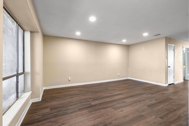 spare room with dark wood-type flooring