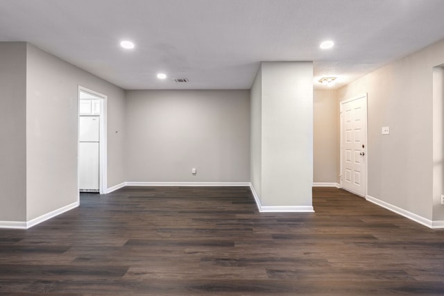 unfurnished room with dark hardwood / wood-style flooring