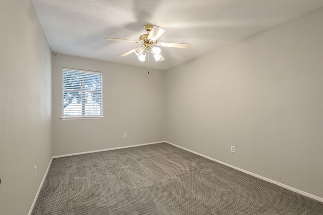 carpeted empty room with ceiling fan and a textured ceiling