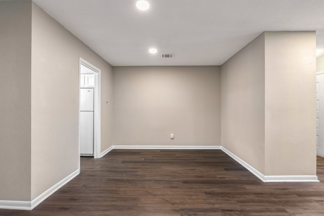 spare room with dark hardwood / wood-style flooring