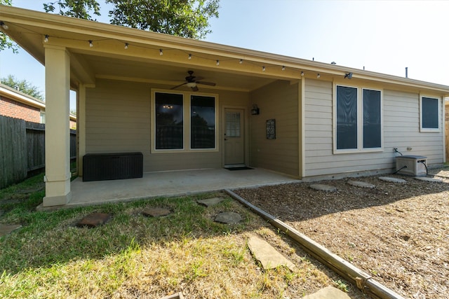 rear view of property with ceiling fan and a patio area