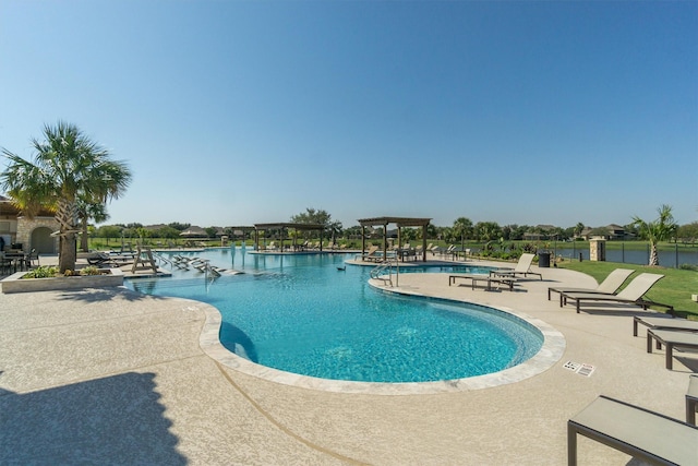 view of swimming pool featuring a patio and a water view