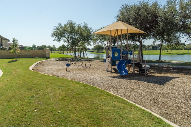 view of jungle gym with a water view and a lawn