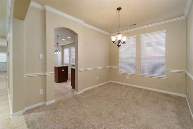 empty room with a notable chandelier, ornamental molding, and light carpet