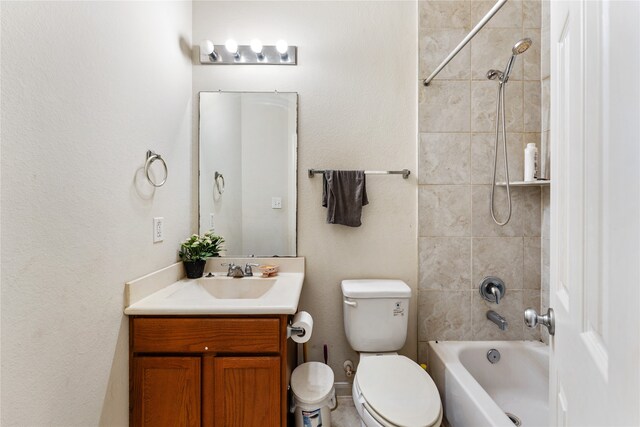 full bathroom with vanity, toilet, and tiled shower / bath