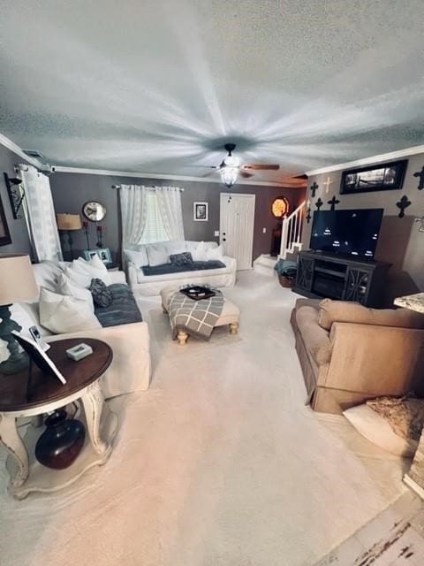 carpeted living room with a textured ceiling and crown molding