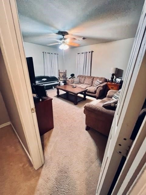 living room featuring a textured ceiling and light colored carpet