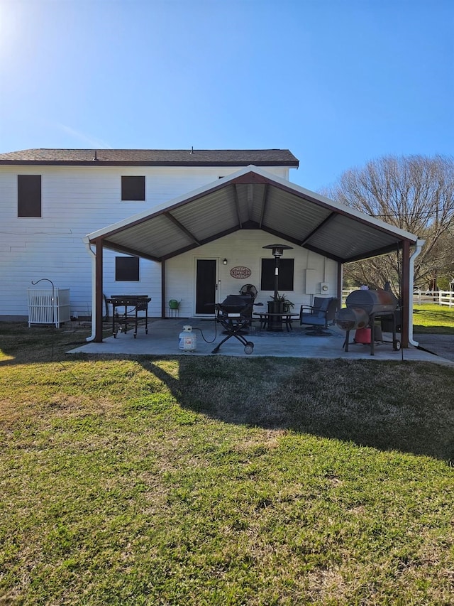 back of house with a lawn and a patio area