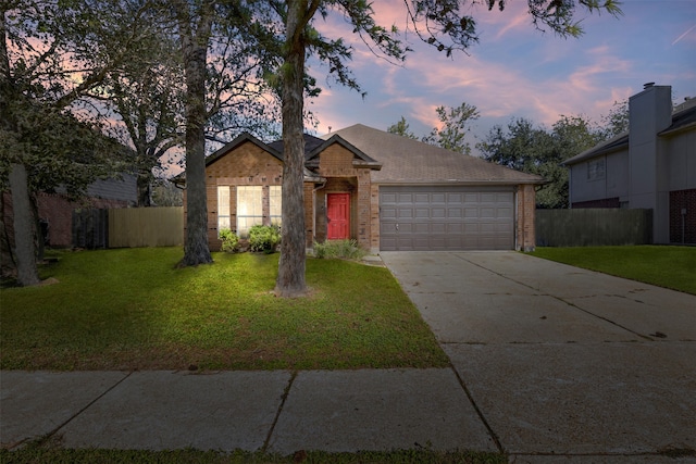 single story home with a yard and a garage