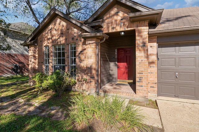 view of exterior entry with a garage