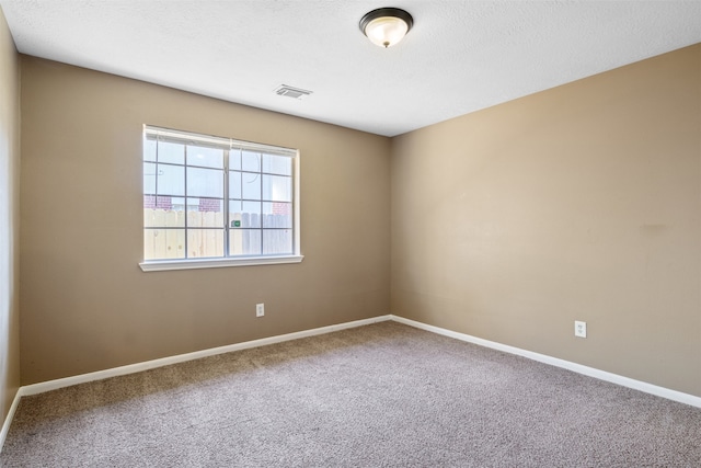 unfurnished room featuring carpet floors and a textured ceiling