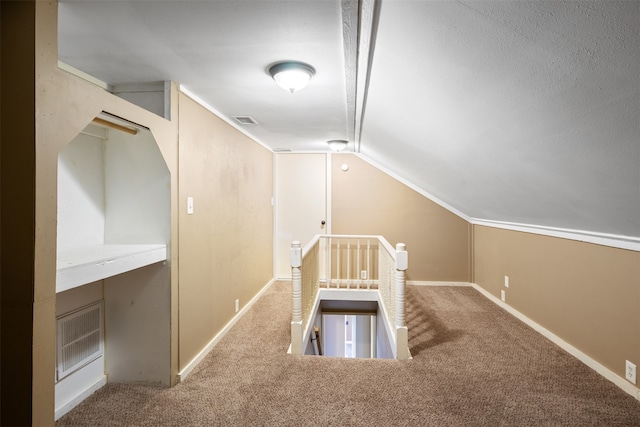 interior space featuring carpet and lofted ceiling