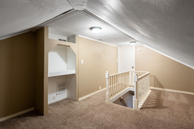 bonus room featuring carpet, lofted ceiling, and a textured ceiling